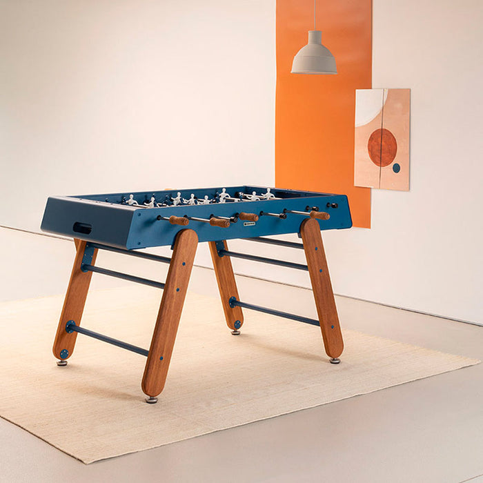 RS Barcelona RS4 Home football table in blue with solid wooden legs, modern designer foosball table in a contemporary interior.