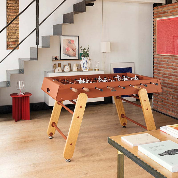 RS Barcelona RS4 Home football table in brown with solid wooden legs styled in a modern living room interior.