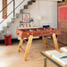 RS Barcelona RS4 Home football table in brown with solid wooden legs styled in a modern living room interior.