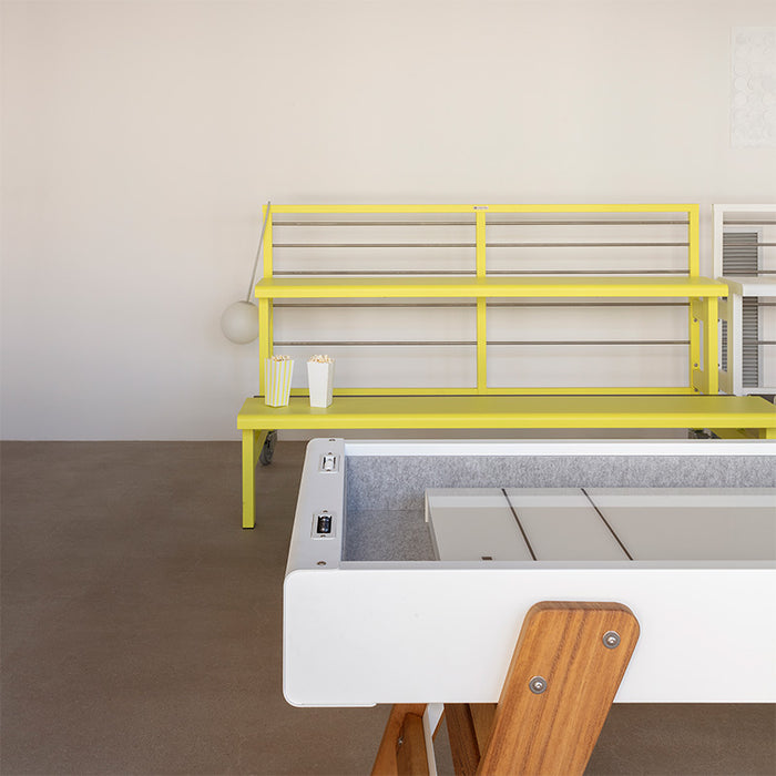 RS Barcelona Track shuffleboard table in blue finish with wooden legs placed in modern interior game room setting.