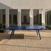 RS Barcelona You and Me monochrome ping pong table in red finish, sleek outdoor table tennis table with modern minimalist design and architectural surroundings.