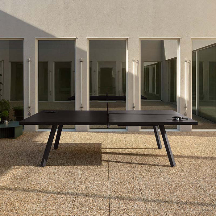 RS Barcelona You and Me monochrome ping pong table in white with integrated net, modern outdoor table tennis table with sleek legs and contemporary architecture backdrop.