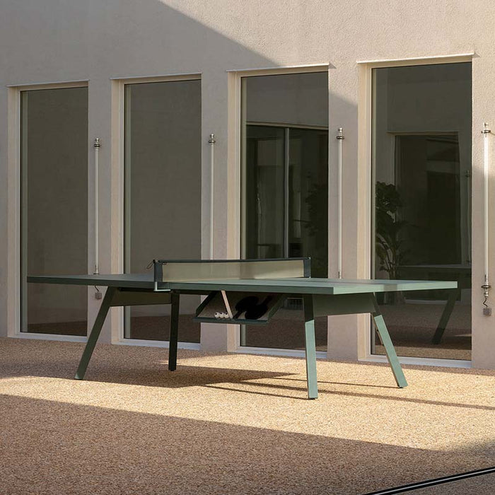 RS Barcelona You and Me monochrome ping pong table in green finish with net, modern outdoor table tennis table with clean lines and architectural backdrop.