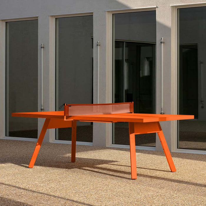 RS Barcelona You and Me monochrome ping pong table in muted green finish with net, modern outdoor table tennis table with sleek legs and architectural surroundings.