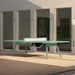 RS Barcelona You and Me monochrome ping pong table in black with paddles, sleek outdoor table tennis table with clean lines in contemporary courtyard setting.