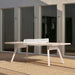 RS Barcelona You and Me monochrome ping pong table in blue with paddles on surface, contemporary outdoor table tennis table in minimalist courtyard setting.