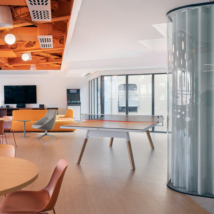 Contemporary lounge area featuring RS Barcelona You and Me ping pong table, stylish table tennis table in modern office breakout space