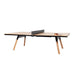 RS Barcelona You and Me ping pong table with natural wood top and black frame, modern table tennis table with wooden legs and net in minimalist studio setting
