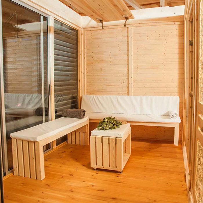 Traditional Sauna Cube Wooden benches and soft seating in a cosy lounge area.