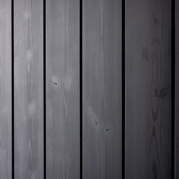 Close-up of the textured black wood panels on the facade of the Saunum AirCube One Outdoor Sauna, highlighting its modern and durable exterior.