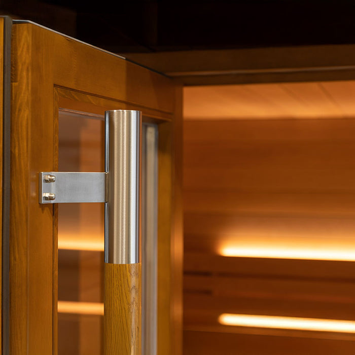 Close-up of the stainless steel and natural oak handle on the Saunum AirCube Space Outdoor Sauna door, highlighting the premium materials and craftsmanship.