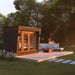 The Saunum AirCube Space Outdoor Sauna installed on a wooden deck in a modern garden, blending seamlessly with outdoor furniture and natural surroundings.