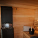 Interior view of the Saunum AirCube Terrace Outdoor Sauna, showcasing the sleek sauna heater, wooden benches, and glass door, creating a relaxing and modern sauna environment.