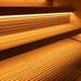 A close-up of the wooden benches and integrated lighting inside the Saunum AirCube Terrace Outdoor Sauna, offering a warm and cosy seating area.