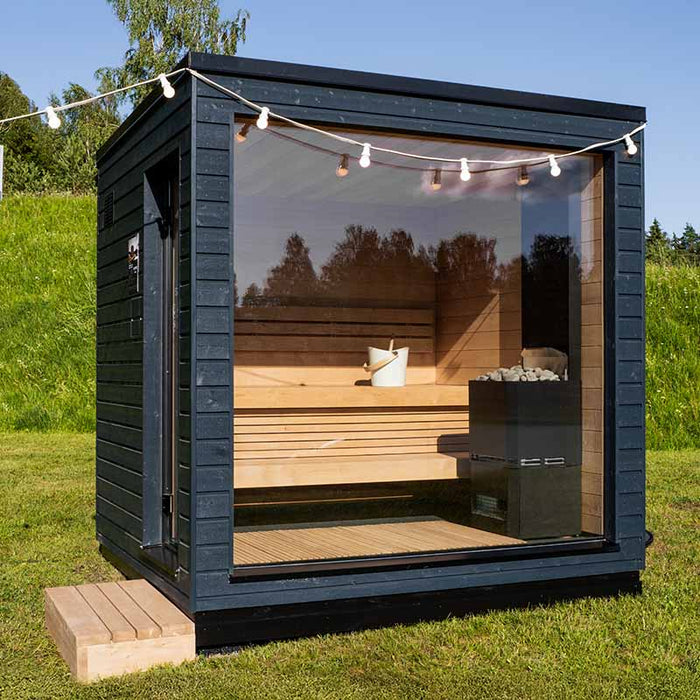 Saunum Classic Outdoor Sauna for 4 Persons surrounded by natural greenery, highlighting the perfect blend of luxury and nature.