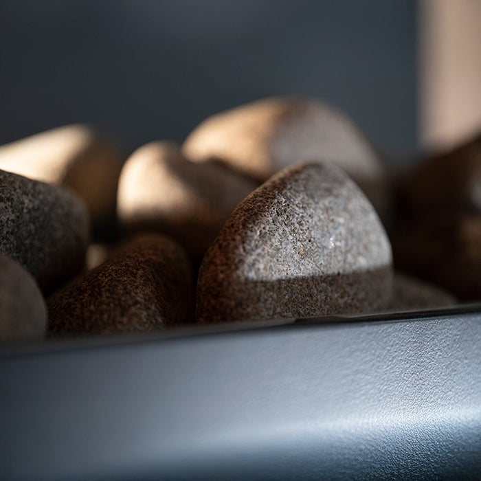 Close-up of sauna heater stones inside the Saunum Classic Outdoor Sauna for 4 Persons, designed to enhance heat distribution and provide an authentic sauna experience.