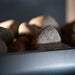 Close-up of sauna heater stones inside the Saunum Classic Outdoor Sauna for 4 Persons, designed to enhance heat distribution and provide an authentic sauna experience.