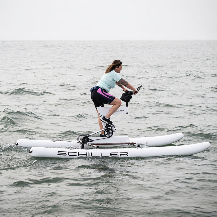 Rider pedalling a Schiller S1-C Water Bike across open water.