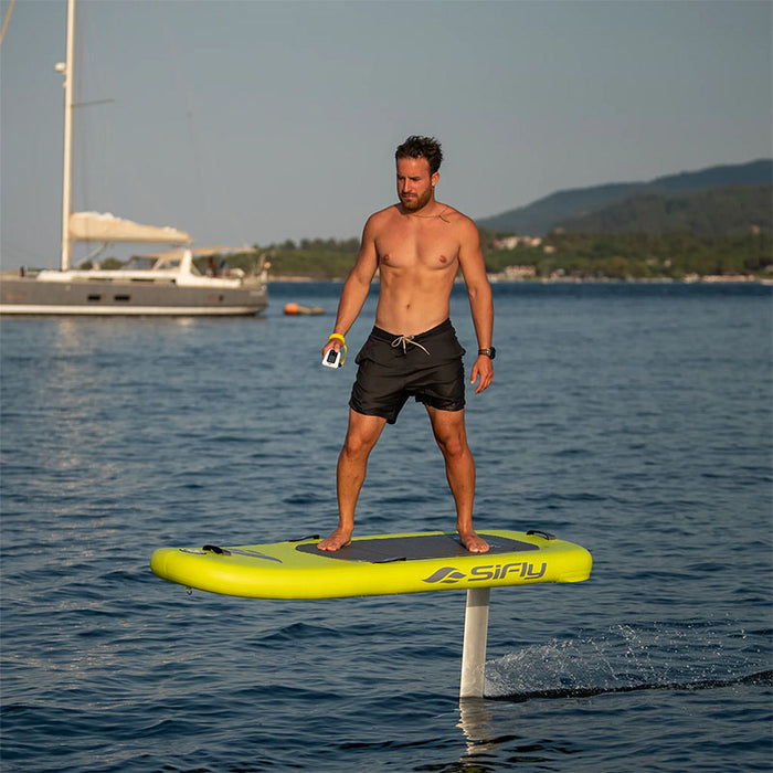 Man riding the yellow SiFly Lite eFoil Set above the water.