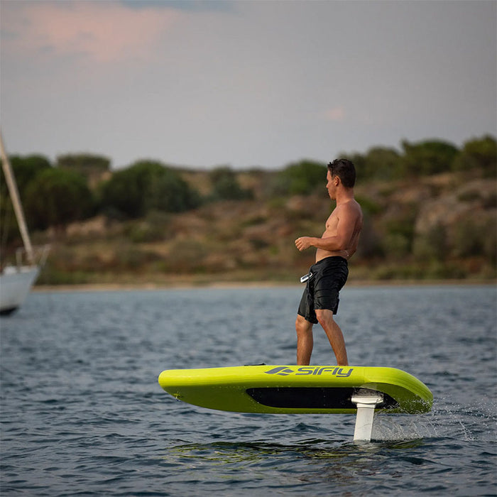 Rider gliding across the water on the yellow SiFly Lite eFoil Set.
