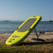 Yellow SiFly Lite eFoil Set resting on grass beside the water.