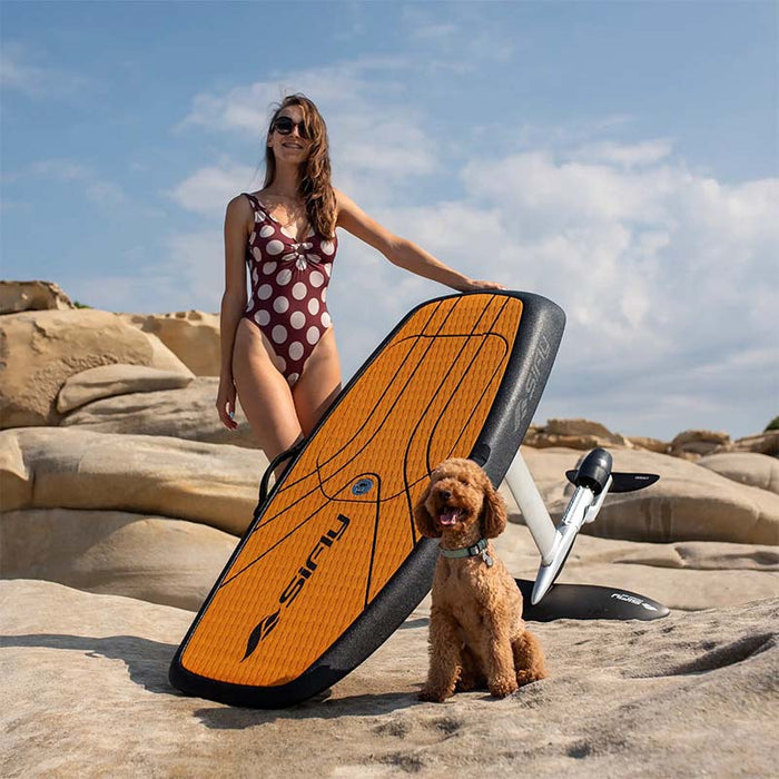 SiFly Rider eFoil Set displayed with a dog beside the board on coastal rocks.