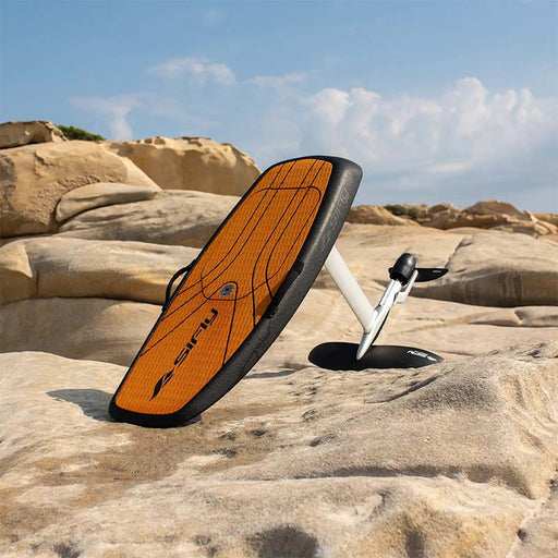 SiFly Rider eFoil Set resting on coastal rocks with its hydrofoil attached.