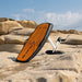 SiFly Rider eFoil Set resting on coastal rocks with its hydrofoil attached.