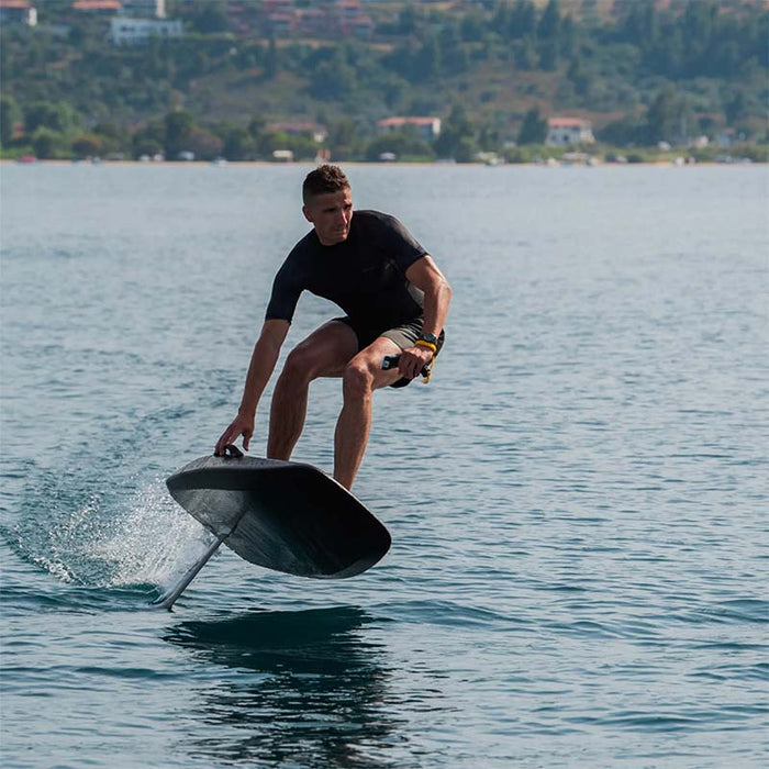 Rider carving across the water on the SiFly Rider eFoil Set.
