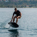 Rider carving across the water on the SiFly Rider eFoil Set.