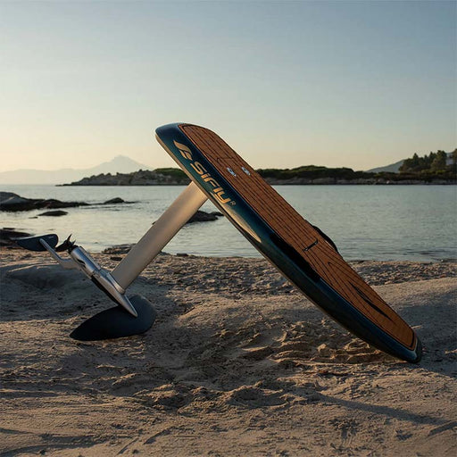 SiFly Stellar blue eFoil Set displayed on a sandy beach with wood-effect deck, mast, motor and hydrofoil wings.