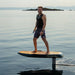 Rider standing on a SiFly Stellar electric foil board while cruising smoothly above calm open water.