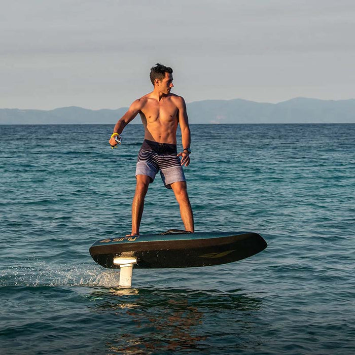 Rider using a SiFly Stellar electric hydrofoil board above the sea, demonstrating eFoil performance on open water.