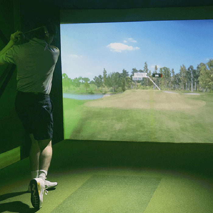 Indoor golfing experience with Simbooth 1 Golf Simulator Kit in a dark green-lit room, featuring lifelike gameplay graphics and swing tracking in compact space.