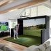 Man playing on the Simbooth 1 Golf Simulator Kit in a stylish home entertainment room, showcasing realistic virtual fairway visuals and premium golf swing analysis technology.