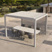 Suns Lifestyle Luxe Electric Louvered Pergola in white, elegantly sheltering a marble-top dining set on a sunlit terrace – ideal for outdoor entertaining and al fresco dining.