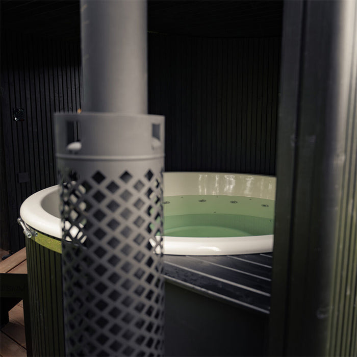 Top view of the filled hot tub integrated into the Tauras Classic 7-person sauna, surrounded by black timber cladding for a premium outdoor spa experience.