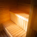 Bright and cosy sauna interior with two-tiered wooden benches, part of the Tauras Classic 7-person sauna and hot tub unit, crafted for group relaxation.