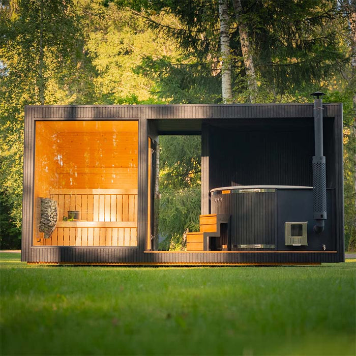 Elegant and contemporary outdoor sauna with integrated hot tub set in a forest landscape, featuring the Tauras Classic’s signature design elements.