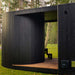 Sleek curved exterior wall of the Tauras Classic 7-person sauna with hot tub, highlighting its modern black timber cladding and architectural craftsmanship.
