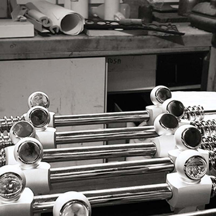 An image depicting the assembly process, with chrome rods and player figurines being meticulously crafted.