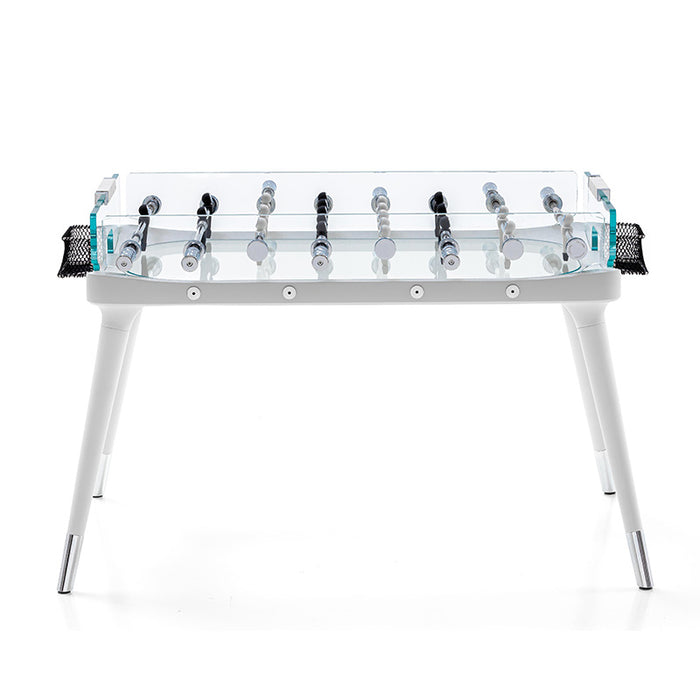 A side perspective of the sophisticated foosball table showcasing the transparent playing field, white structure, and polished handles. The minimalist design is complemented by the netted goal.