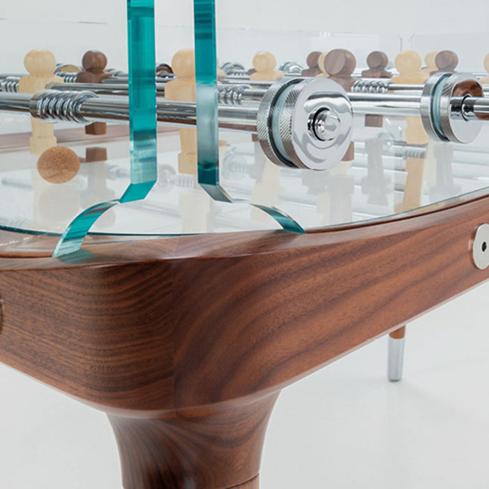 Close-up of the edge of the Teckell 90 Minuto Wood Foosball Table - III Noce Italiano, featuring the smooth walnut wood finish and glass.