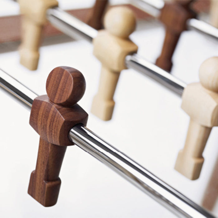 Detailed view of dark wood and light wood player figures on the Teckell 90 Minuto foosball table.