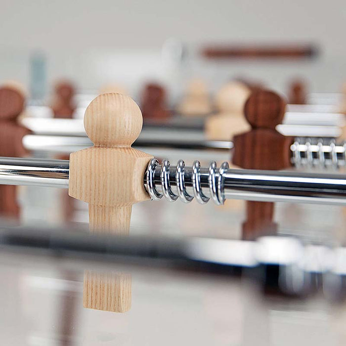 Detailed shot of the wooden player figure on the Teckell 90 Minuto walnut wood foosball table, highlighting the craftsmanship.