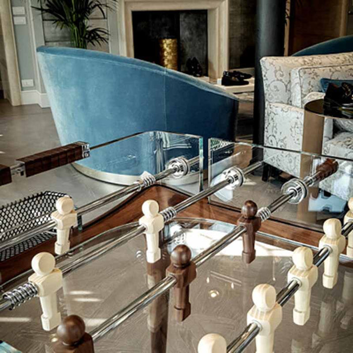 The Teckell 90 Minuto walnut wood foosball table in a stylish living room, showcasing its integration with modern decor.