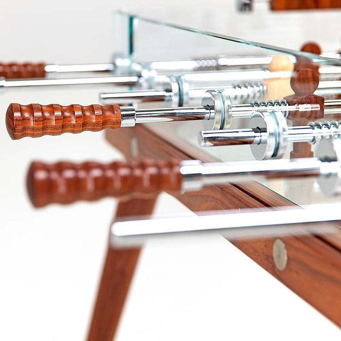 Close-up of the ergonomic wooden handles on the Teckell 90 Minuto walnut wood foosball table, highlighting their smooth finish.