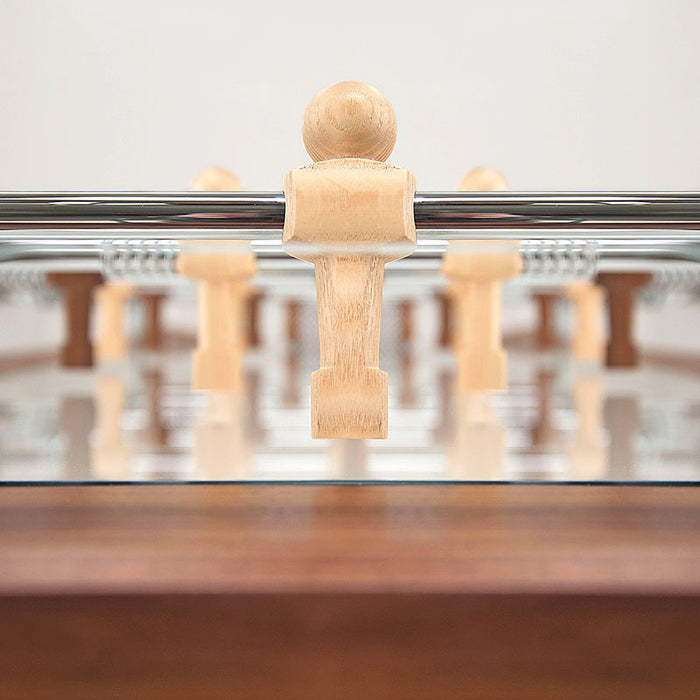 Close-up of a light wood player figure on the Teckell 90 Minuto foosball table.