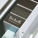 Close-up of the Teckell branding and engraving on the chrome elements of the Cristallino Black Foosball Table.