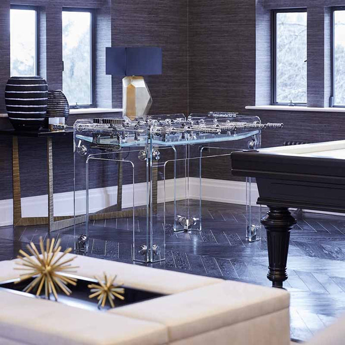 The Teckell Cristallino Classic Foosball Table in a luxurious game room, surrounded by elegant decor.